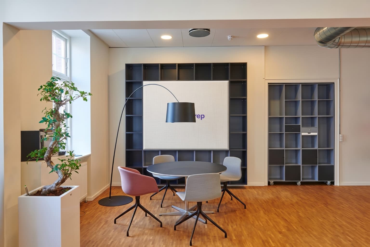 Meeting table in front of a bookcase with the TestPrep logo